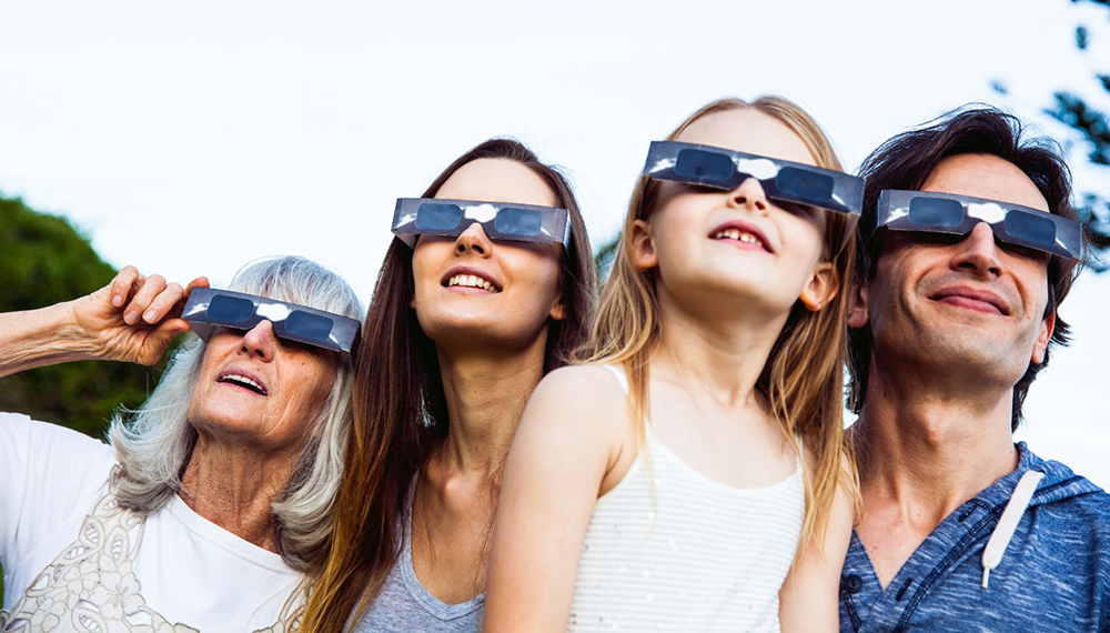 family wearing eclipse glasses